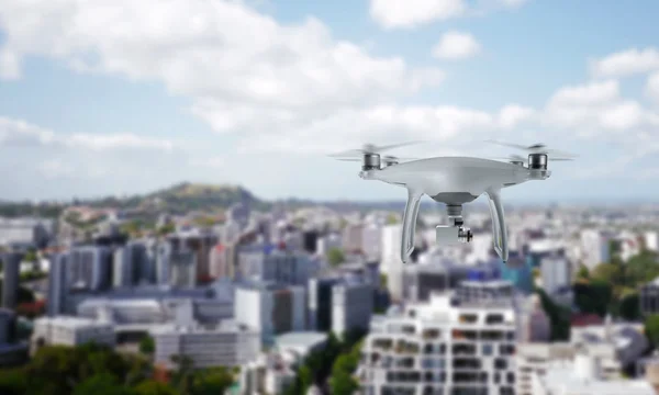 Drone quad copter with camera flying over the city center.