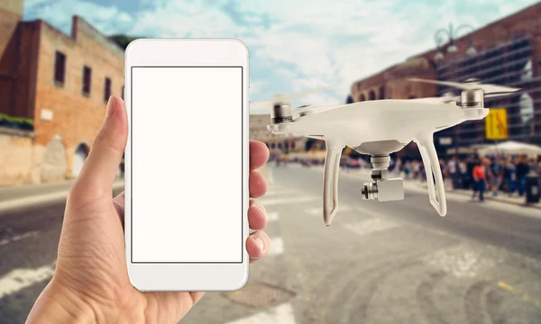 Smart phone with isolated white screen control drone. City street in background.