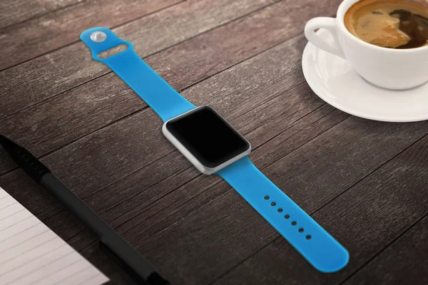Smartwatch with blank screen for mockup. Isometric view. Cup of coffee beside on table.