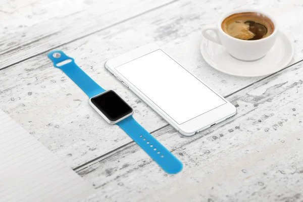 Smartwatch and phone with blank screen for mockup. Isometric view. Cup of coffee beside on table.