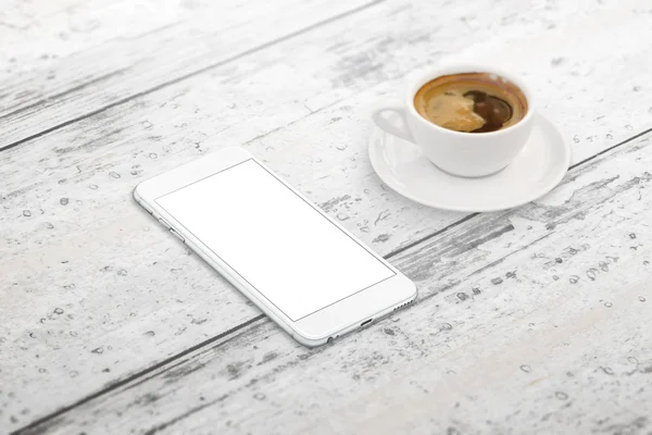 Smart phone with blank screen for mockup. Cup of coffee beside on table. Isometric view.