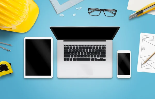 Laptop computer, tablet and smart phone on designer desk. Mockup for responsive web site promotion.