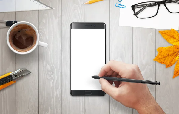 Man writes with a pencil on phone display