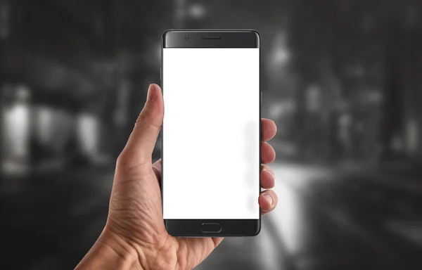 Modern black smart phone with isolated white display for mockup in man hand