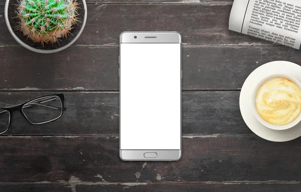Modern silver smart phone with white isolated display for mockup in wooden table