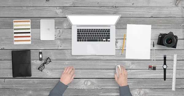 Desk with a laptop and camera from top