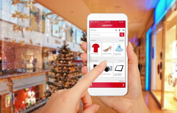 Smart phone online shopping in woman hand during Christmas