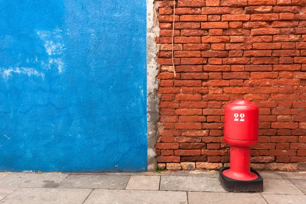 Detail of a blue wall with hydrant from Burano island, Venice