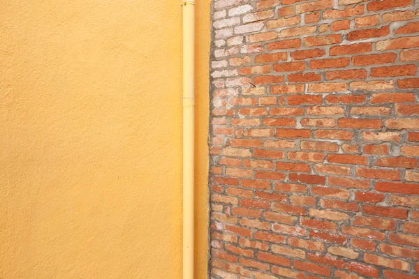 Detail from an external yellow wall in Burano island, Venice