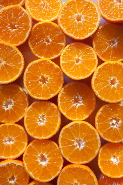 Orange cut tangerines on a table as background