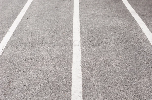 The texture of an asphalt road with marking lines