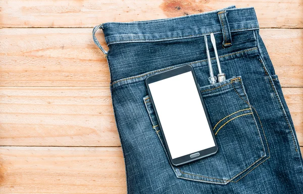 The jeans with mobile phone and screwdriver tool in pocket on wo