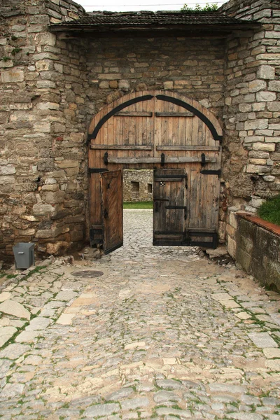Entrance to the castle through a wooden gate