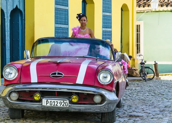 Young girl in pink car