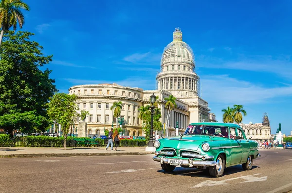 Old classic American grenn car and Capitol, Cuba