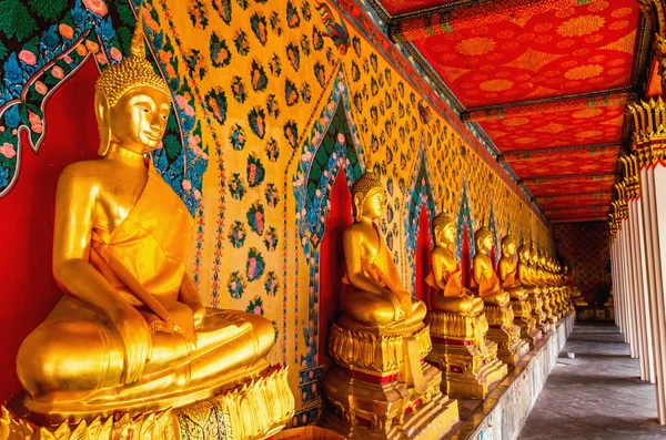 Golden Buddhist statues at temple in Bangkok