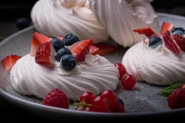 Pavlova berry cake with blueberries, strawberries and rasberries