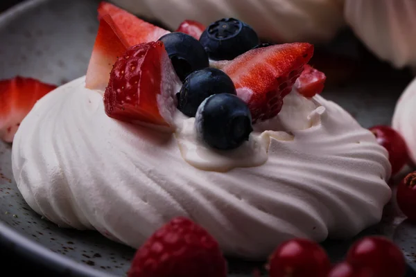 Pavlova berry cake with blueberries, strawberries and rasberries