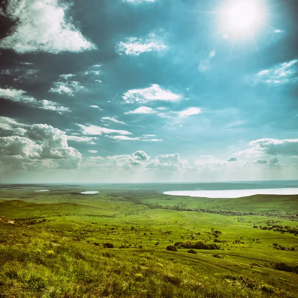 Photo of beautiful landscape with grassy land under sunny skies in vintage style