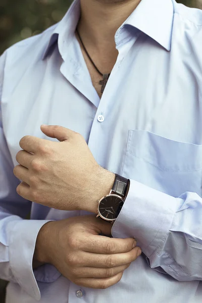 Sexy man in luxury blue shirt with watch