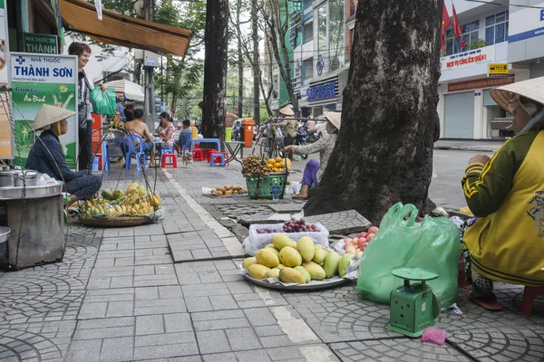 Produce, fruit and wares vendors on footpath in Saigon, Ho Chi Min City.