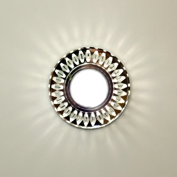 Bright circular lamp on the ceiling, lighting indoors background
