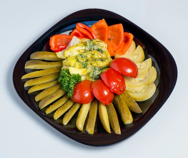 Mixed pickled vegetables in black plate