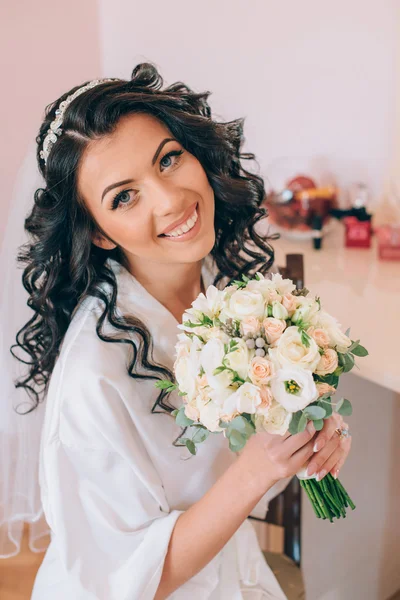 Beautiful happy bride with wedding hairstyle bright makeup in br