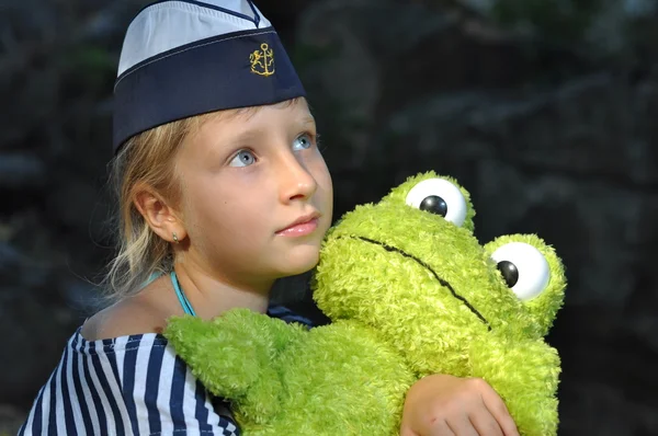 Sailor girl with a toy frog