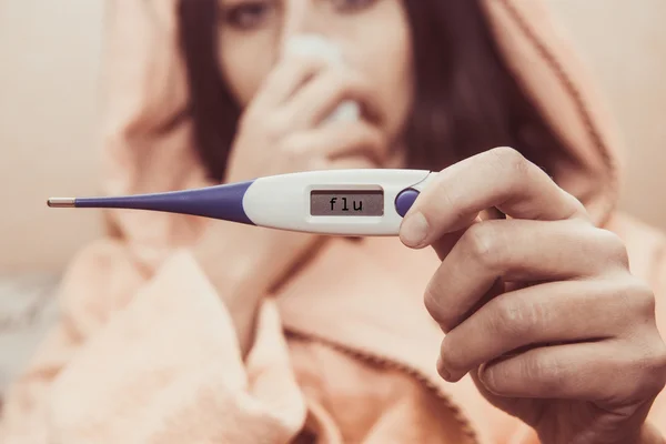 The digital thermometer in hands