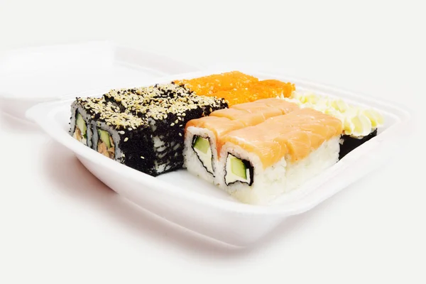 Japanese rolls in a restaurant with fish and vegetables in container box isolated on white background