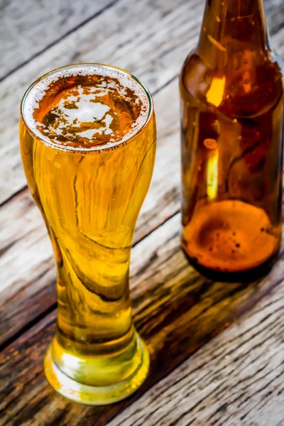 Glass beer and Bottle beer on wood background