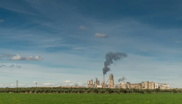 Green Field And Factory With Dark Smoke Coming Out Of Chimney