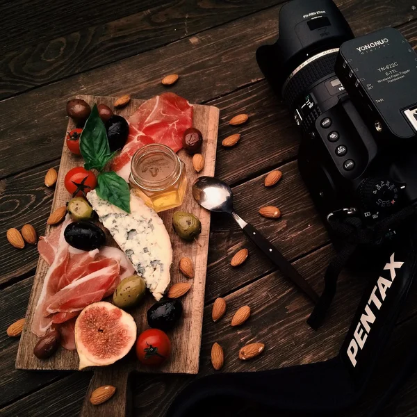 Food and camera on wooden table