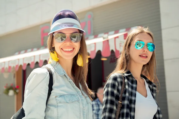 Lifestyle of two best friends laughing outdoor on the street