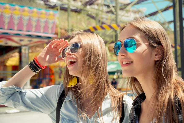 Lifestyle of two best friends laughing outdoor on the street