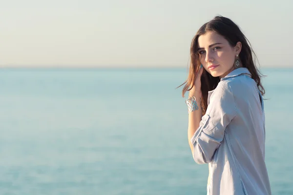 Woman in shirt get wet in the sea