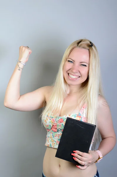 Happy woman college student winner celebrating isolated on grey background