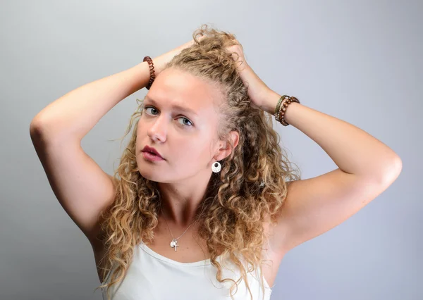 Curly woman pulling her hair