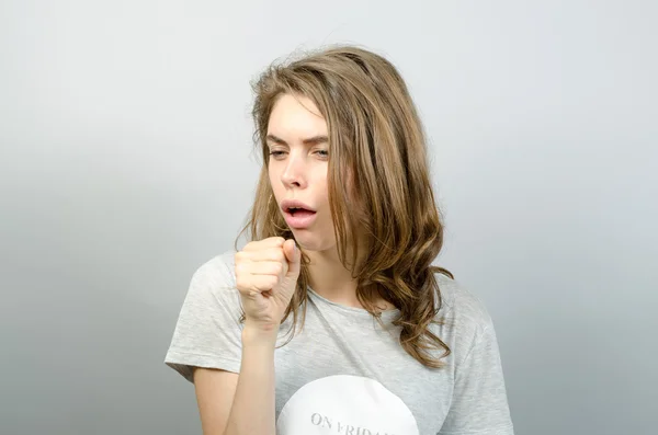 Coughing girl on gray background