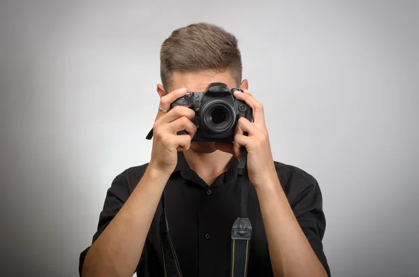 Man taking picture with photo camera DSLR