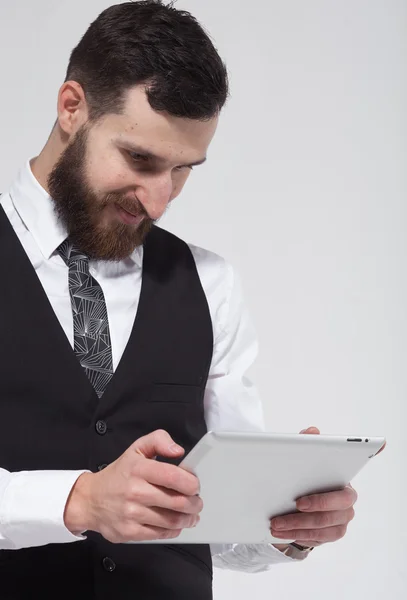 Portrait of a bearded business man using a tablet. On white background.