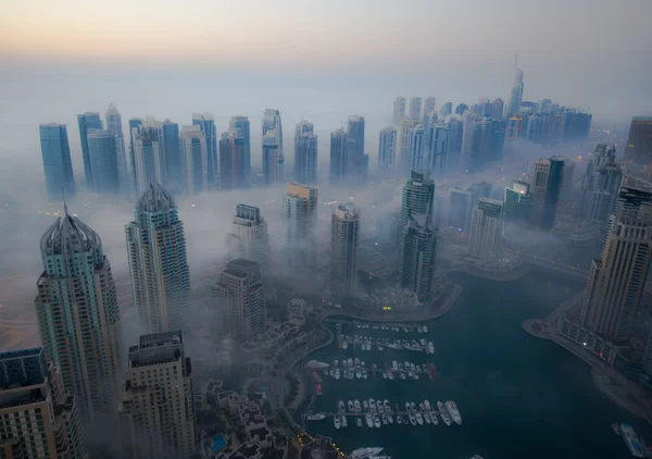 Aerial view skyscraper foggy weather Dubai Marina at morning