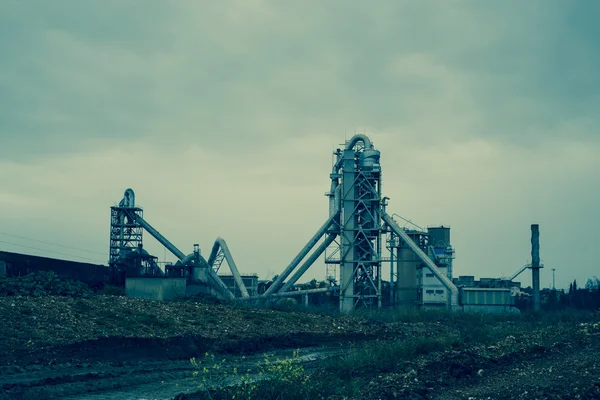 Cement factory industrial plant of sand and gravel surrounded of green area