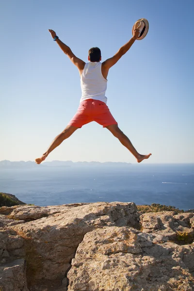 Boy with open arms jumping for joy celebrating freedom