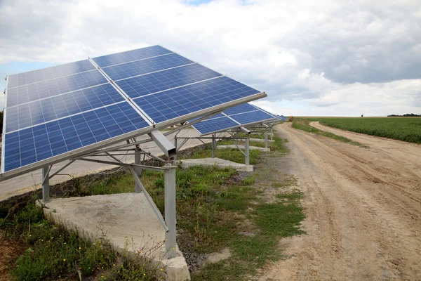 Solar panels near a rural road. Installation of solar panels in rural areas.