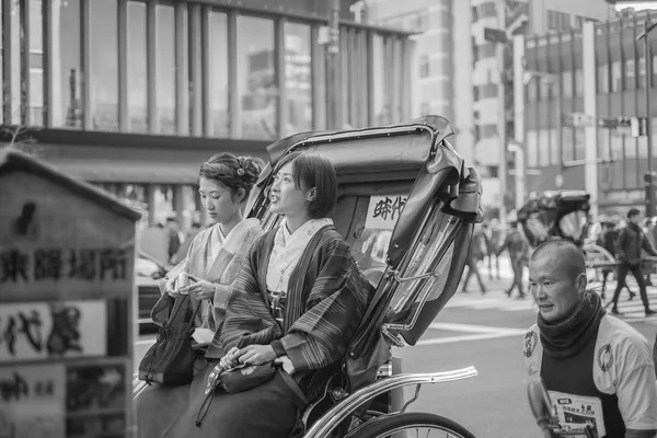 TOKYO, JAPAN - January, 2015: Happy Japanese couple rides on