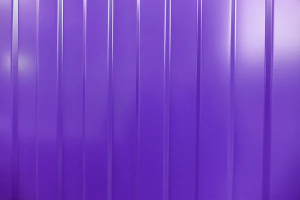 Corrugated iron is new. Texture color. Background lilac.
