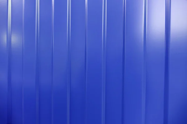 Corrugated iron is new. Texture color. Background blue.