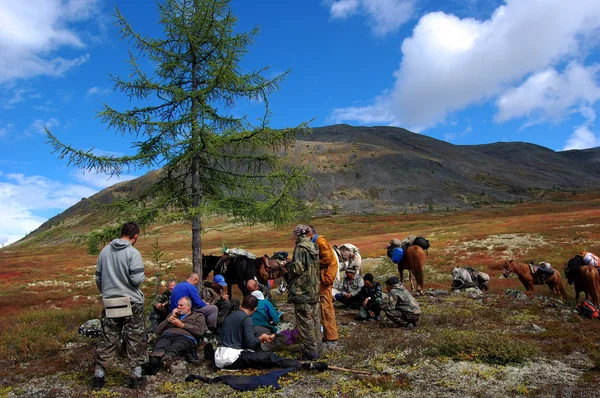 Group of tourists resting on the mountain pass.